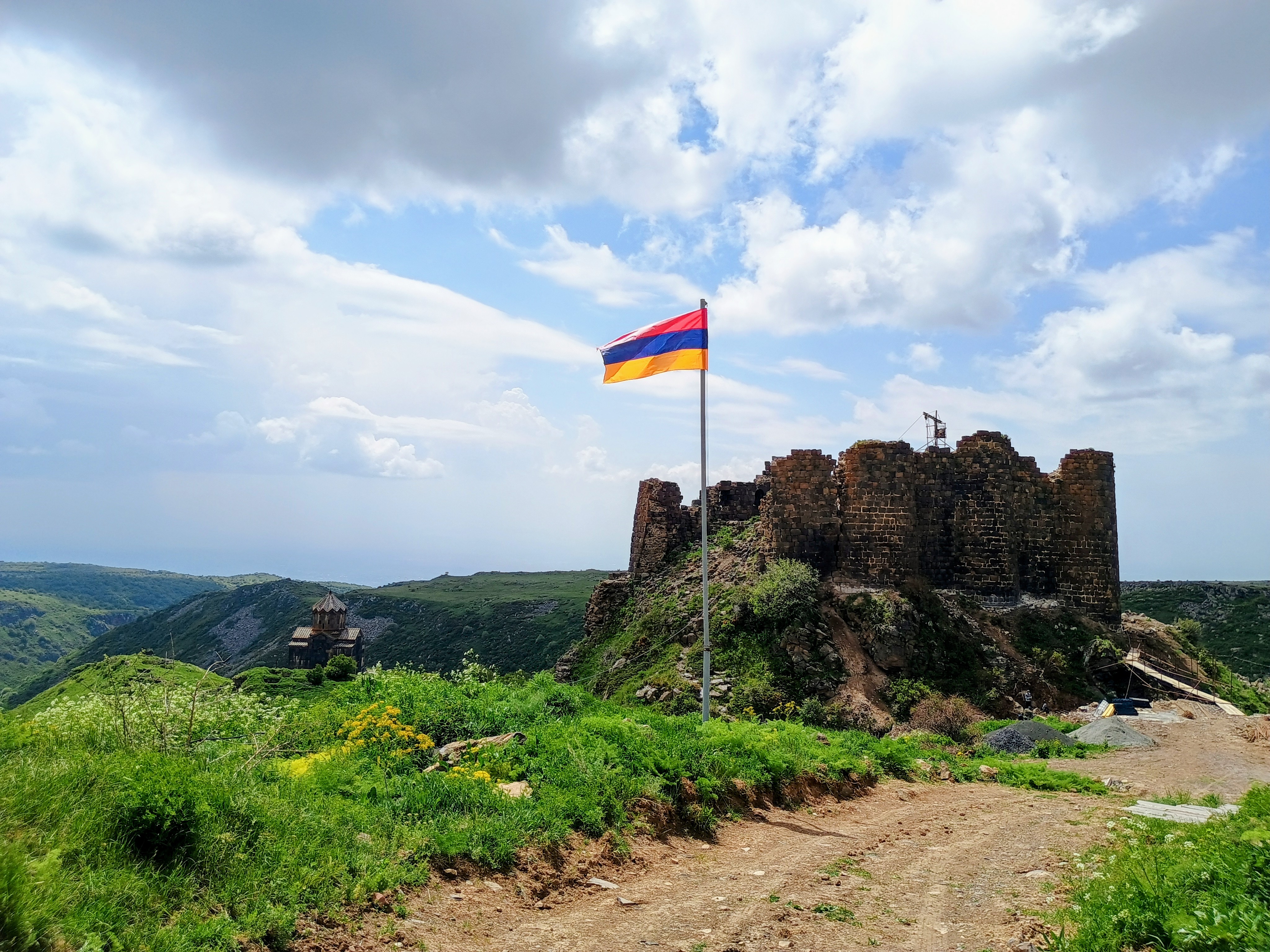 The Armenian flag flying over the ruins of Amberd fortress on the slopes of Mount Aragats